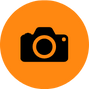 A black camera icon centered on an orange circular background, reminiscent of a professional tool used by home inspectors in Long Island during commercial inspections.